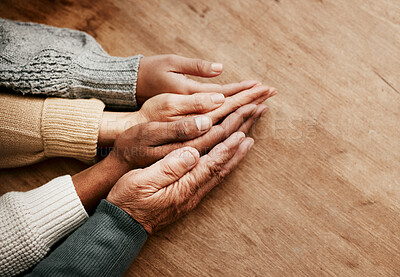 Buy stock photo People, hands together and generations in support above on mockup for unity, compassion or trust on wooden table. Group holding hand in collaboration, love or care for community, teamwork or union