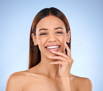 Buy stock photo Portrait, skincare and woman with laugh, cosmetics and happiness against blue studio background. Face, Latino female and lady with smile, dermatology and morning routine for confidence and soft skin
