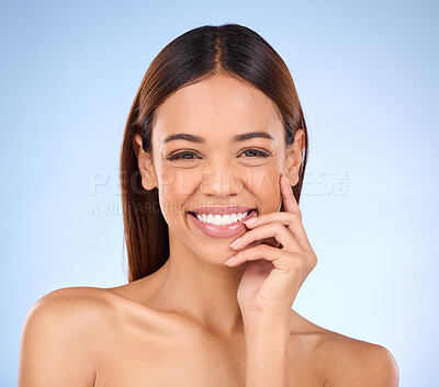 Buy stock photo Beauty, portrait and woman with smile, dermatology and treatment against a blue studio background. Face, female and lady with joy, morning routine and skincare for grooming, clear and smooth skin