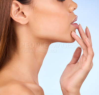 Buy stock photo Skincare, zoom and woman with hand on lips in studio for skin or lip care promo on blue background. Makeup, facial and cosmetics, profile face of model from Brazil for dermatology or lipstick closeup