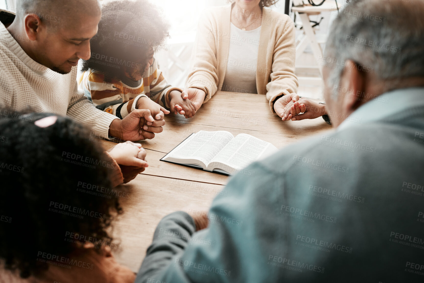 Buy stock photo Holding hands, family and group praying, bible and support with quality time, connect and gratitude. People, believers and community with solidarity, religion and holy book with hope and faith in God