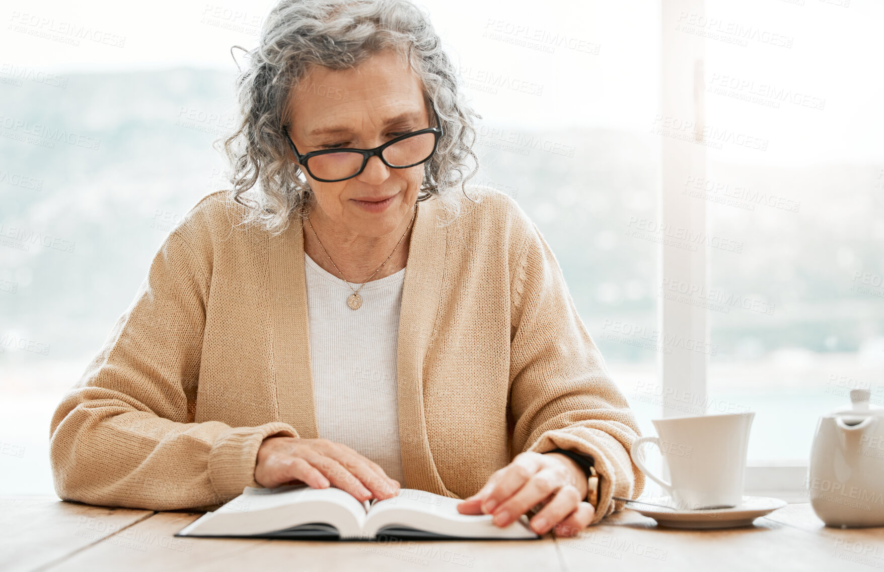 Buy stock photo Old woman reading book, story or bible to relax in hobby or retirement for peace or learning religion. Elderly studying or calm senior person with novel for information or knowledge on table at home