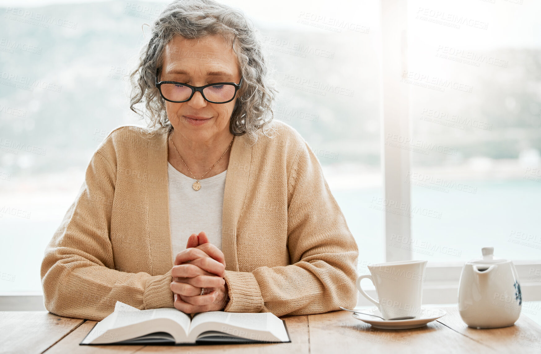 Buy stock photo Bible, reading book or senior woman in prayer for holy worship, support or hope in Christianity or faith. Praying, tea or catholic elderly person studying or learning God in spiritual religion alone