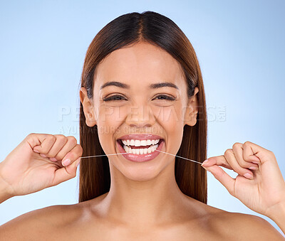 Buy stock photo Dental floss, happy portrait and woman smile with teeth hygiene, healthcare and wellness treatment. Isolated, blue background and studio with a female feeling beauty from a clean mouth with self care