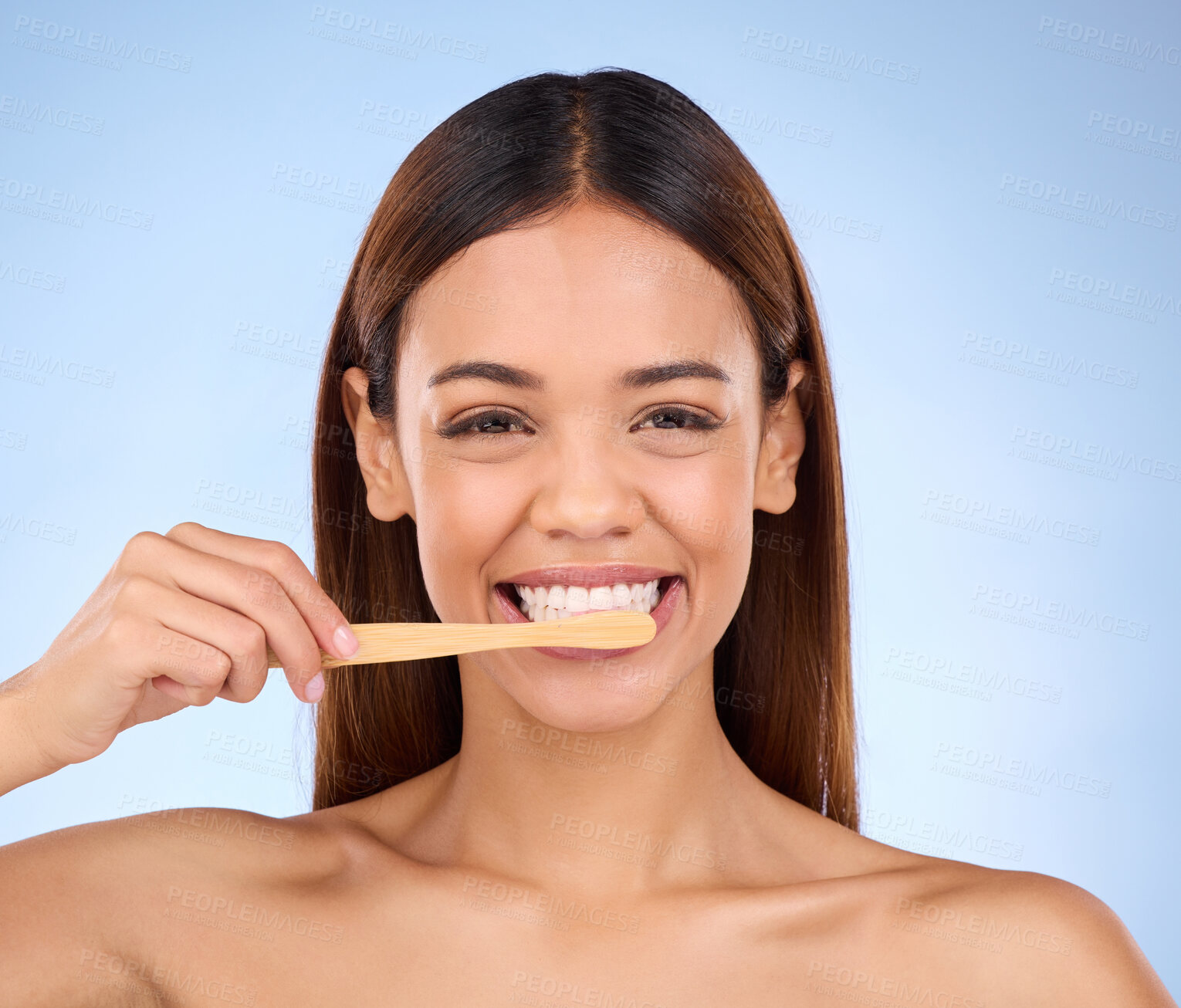 Buy stock photo Portrait, toothbrush and smile with a model woman in studio on a blue background for oral hygiene. Mouth, cleaning and dental with an attractive young female brushing her teeth for whitening