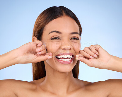 Buy stock photo Dental floss, portrait and woman smile with teeth hygiene, healthcare and wellness treatment. Isolated, blue background and studio with a female feeling beauty from a clean mouth with self care