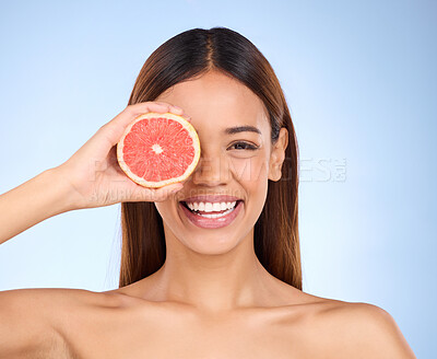 Buy stock photo Beauty, grapefruit and woman for face portrait with a smile for skincare dermatology and vitamin c. Model on blue background for self care, facial glow and healthy fruit for natural skin in studio