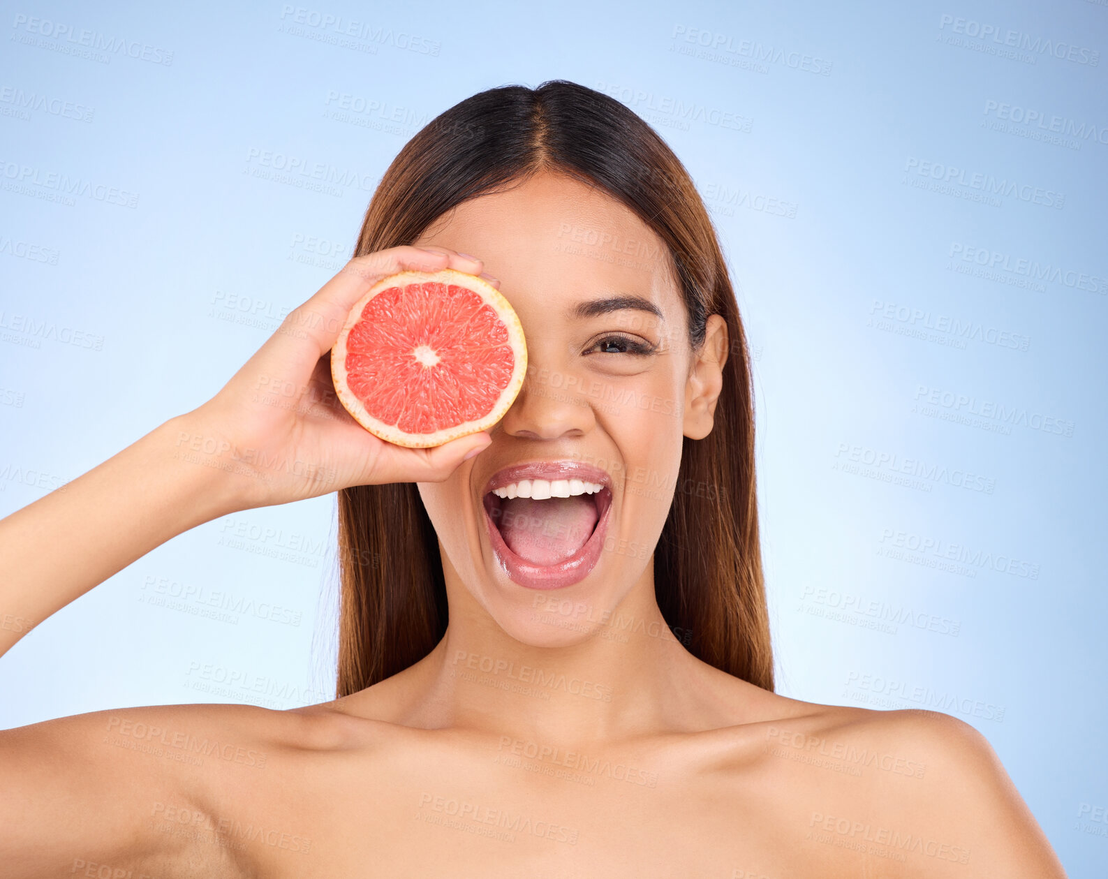 Buy stock photo Beauty, excited woman and grapefruit portrait for skincare cosmetic and vitamin c. Female model on blue background for self care, facial glow or healthy fruit on natural skin and happy face in studio