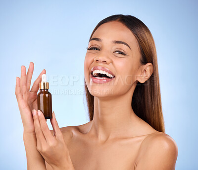 Buy stock photo Beauty, skincare and hispanic woman holding serum with smile for anti aging skin glow on blue background. Cosmetics, facial repair and face of model with solution or collagen product in studio promo.