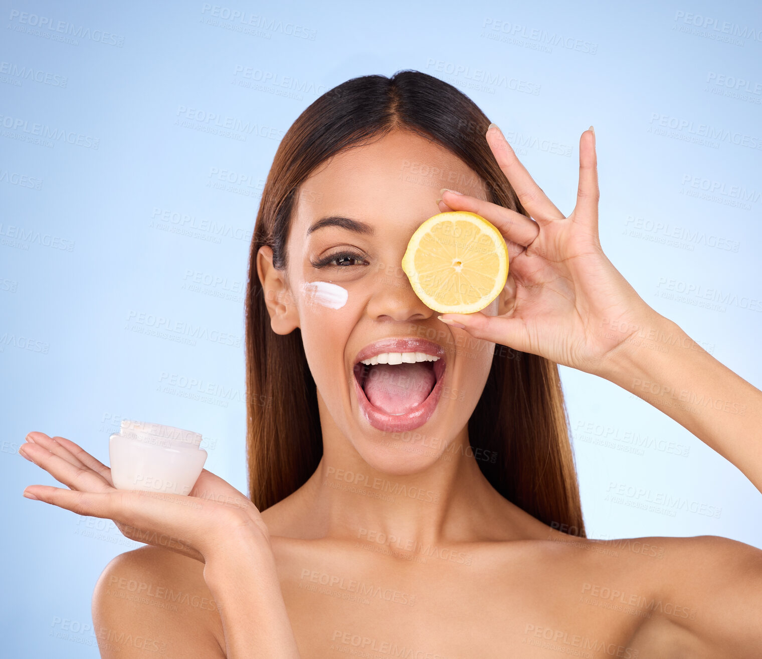 Buy stock photo Woman, moisturizer cream and lemon for natural skincare, beauty and vitamin C against blue studio background. Portrait of happy female holding citrus fruit, creme or lotion for healthy organic facial