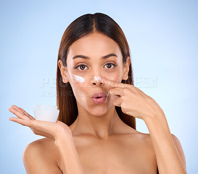 Buy stock photo Skincare, beauty and portrait of woman with cream for anti aging or skin glow on blue background. Cosmetics, facial repair and face of model with moisturizer solution or collagen product in studio.