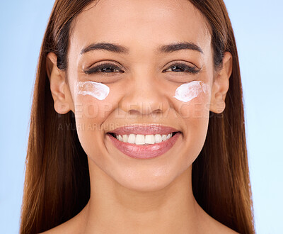 Buy stock photo Skincare, eye cream and fresh face of happy woman with anti aging skin care beauty treatment on blue background. Cosmetics, facial and portrait of hispanic model with collagen product in studio promo