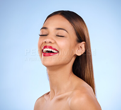Buy stock photo Beauty, woman and red lipstick makeup while laughing with cosmetics on face in studio. Happy aesthetic female model person on a blue background for self care, facial glow and shine or color for skin