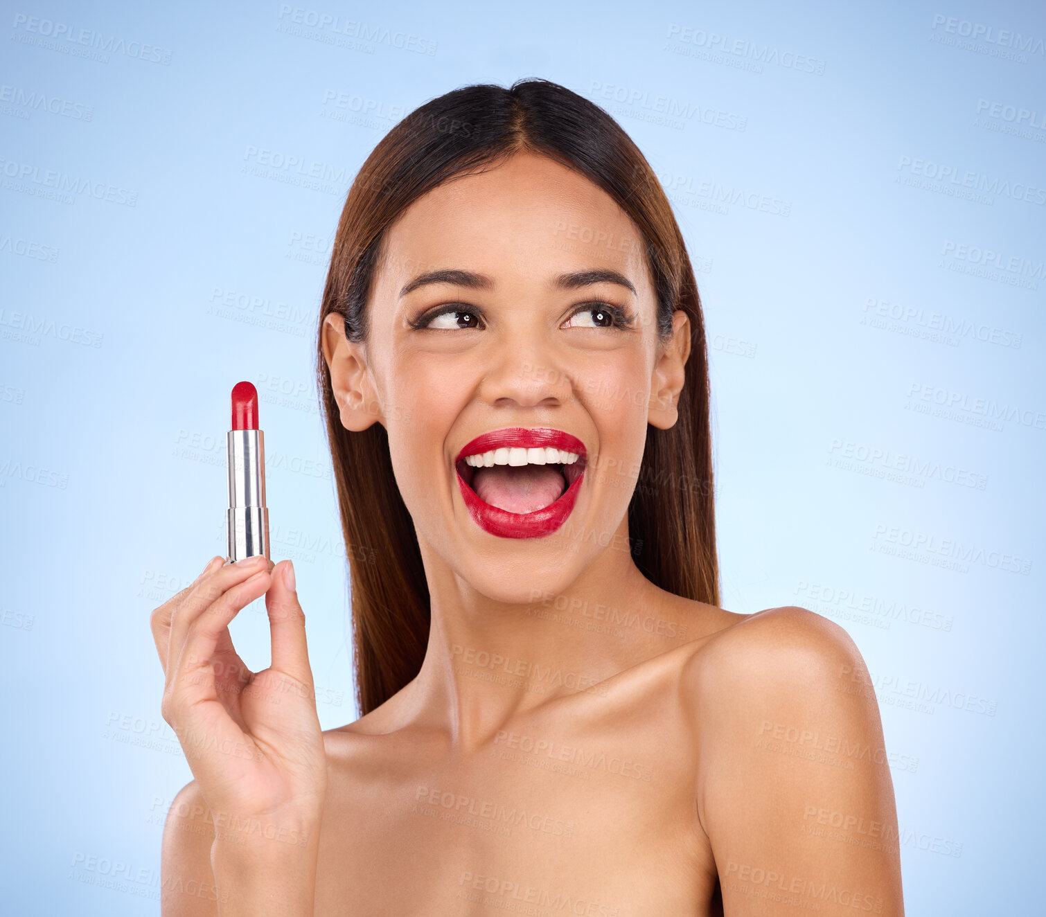 Buy stock photo Beauty, red lipstick and makeup of woman thinking about skincare or cosmetics promotion in studio. Excited female model on a blue background for self care, facial glow and skin with product color