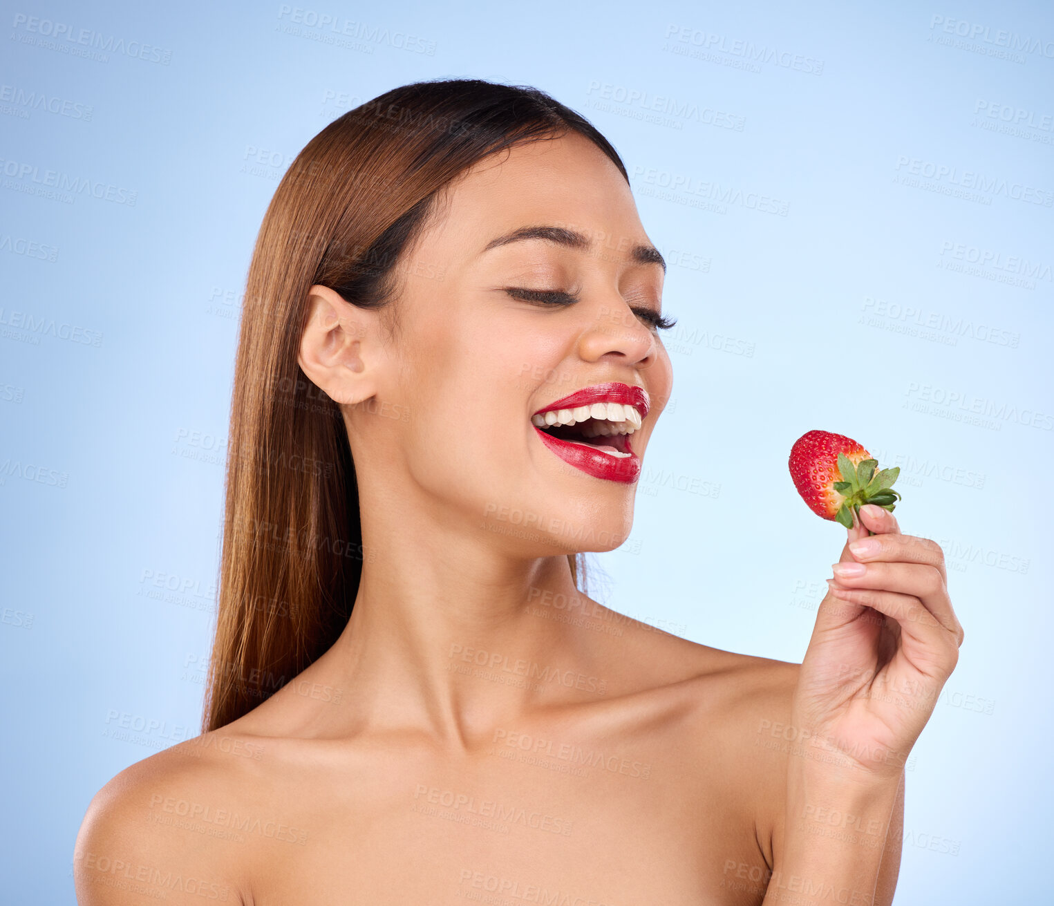 Buy stock photo Beauty, health and strawberry with woman in studio for nutrition, diet and detox. Organic food, natural cosmetics and self care with girl model eating fruit on blue background for wellness and glow