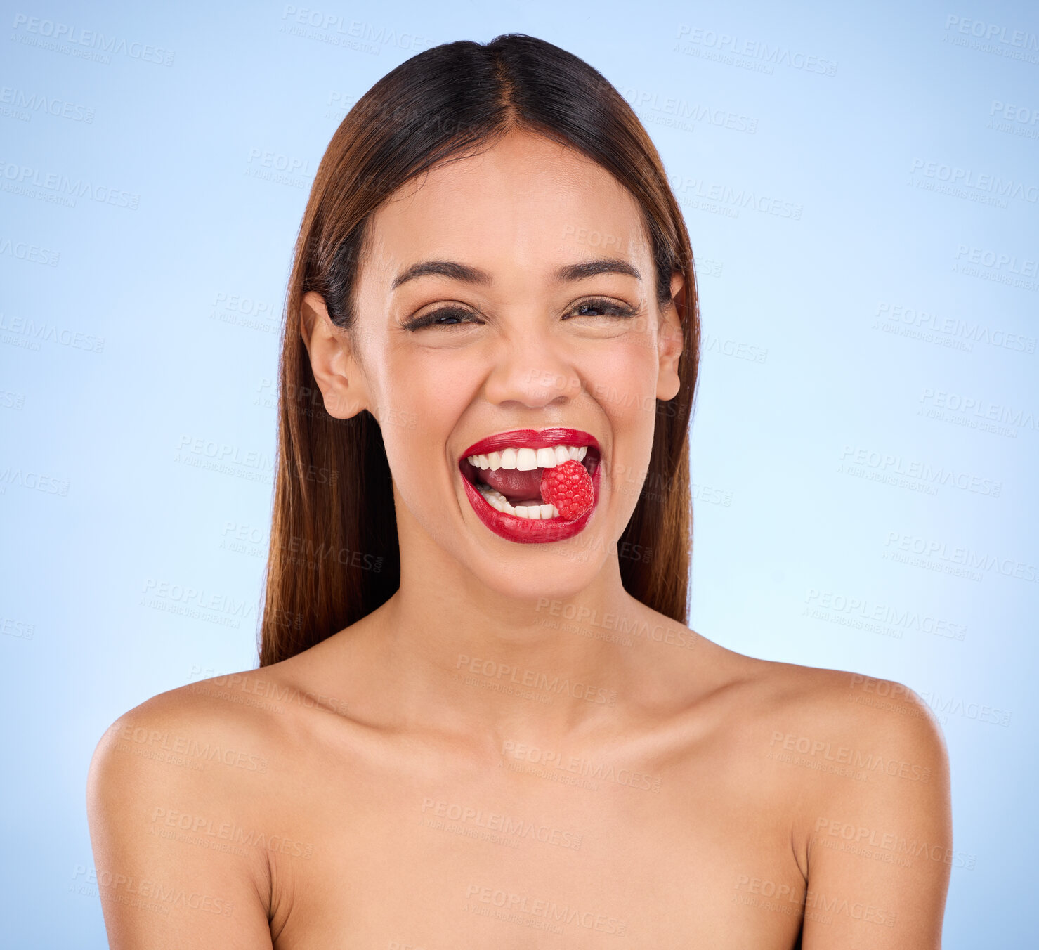 Buy stock photo Beauty, health and raspberry with woman in studio for nutrition, diet and detox. Organic food, natural cosmetics and self care with girl model eating fruit on blue background for wellness and glow