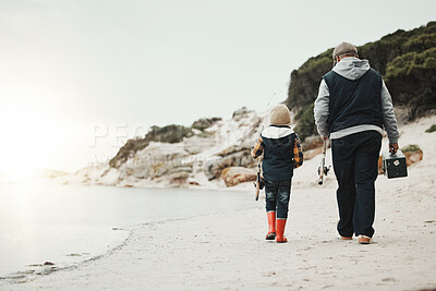 Bonding, back and child with grandfather for fishing, recreation and learning to catch fish at beach. Morning, holiday and boy on a walk by the sea with an elderly man to learn a new hobby together