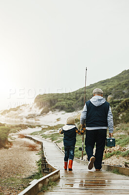 Buy stock photo Walking, fishing and grandfather with child outdoor for lesson, leisure activity or hobby. Travel, bonding and back of senior man with kid to teach him to catch fish while on vacation or weekend trip