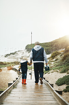 Buy stock photo Fishing, child and grandfather walking on beach pier with tools from back, bonding time on weekend with mockup. Nature, family and old man with boy holding hands and learning catch fish in Greece.
