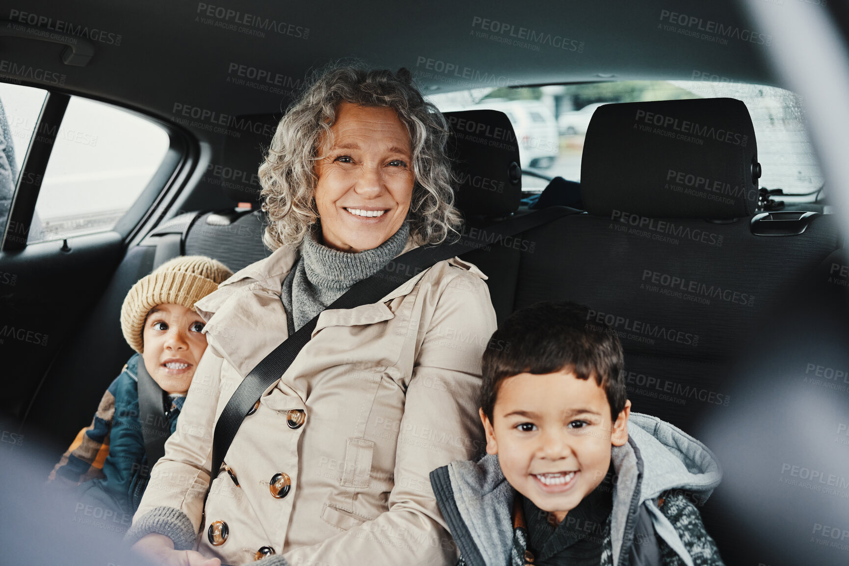 Buy stock photo Portrait, car ride and grandmother relax with children or grandchildren while travel or on a road trip in the backseat. Bonding, happy and grandma traveling with kids or grandkids on a journey