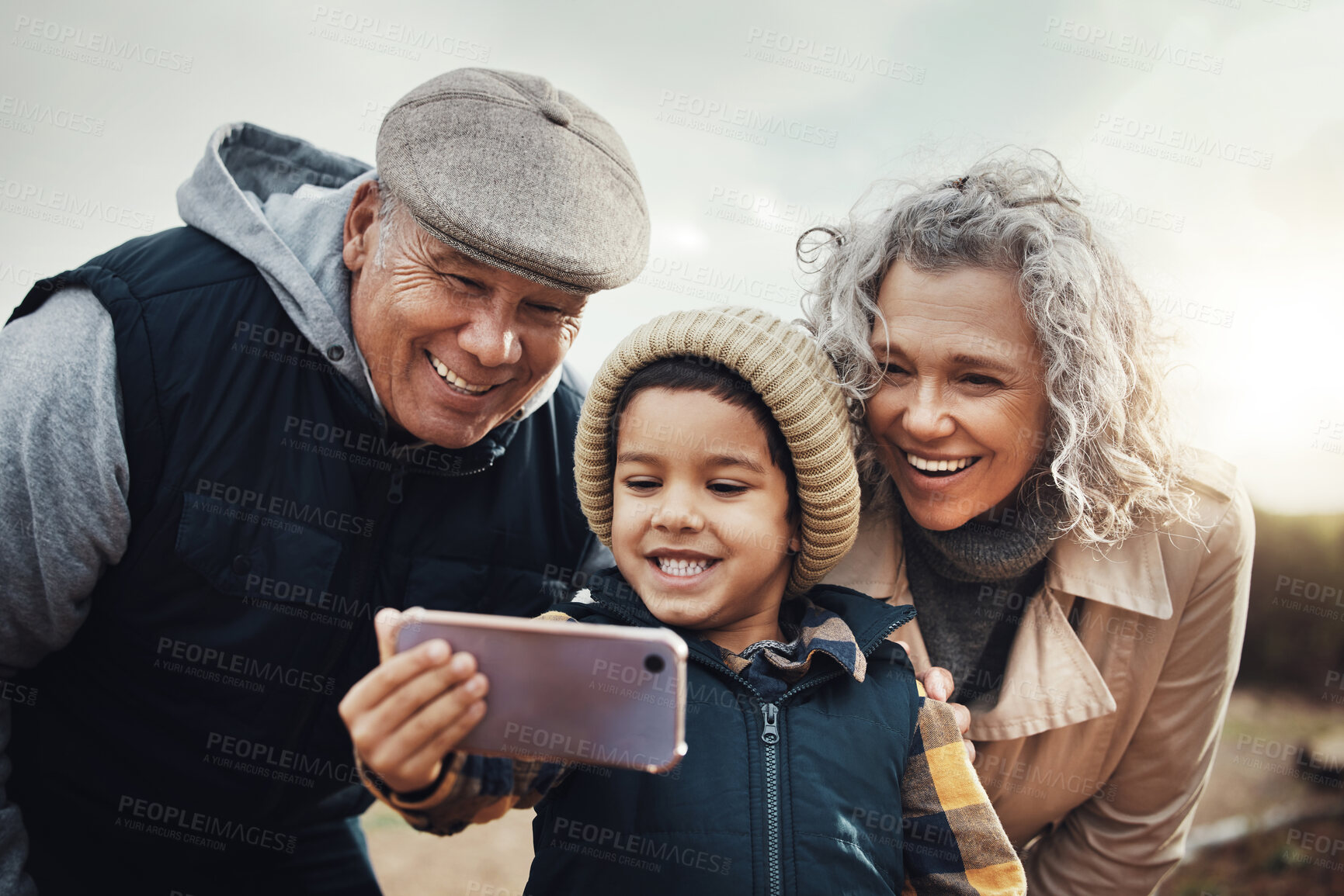Buy stock photo Selfie, happy and child with grandparents in nature for bonding, quality time and babysitting. Smile, interracial and boy taking a photo with a senior man and woman for a holiday or weekend memory