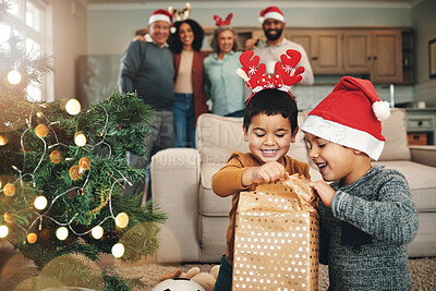 Christmas, curious and children opening gifts, looking at presents and boxes together. Smile, festive and kids ready to open a gift or present under the tree for celebration of a holiday at home