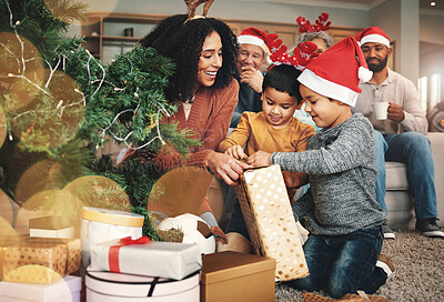 Christmas, family and boys opening a gift, celebrating a holiday and happy with a box. Smile, giving and excited children starting to open a present from their mother during festive season together