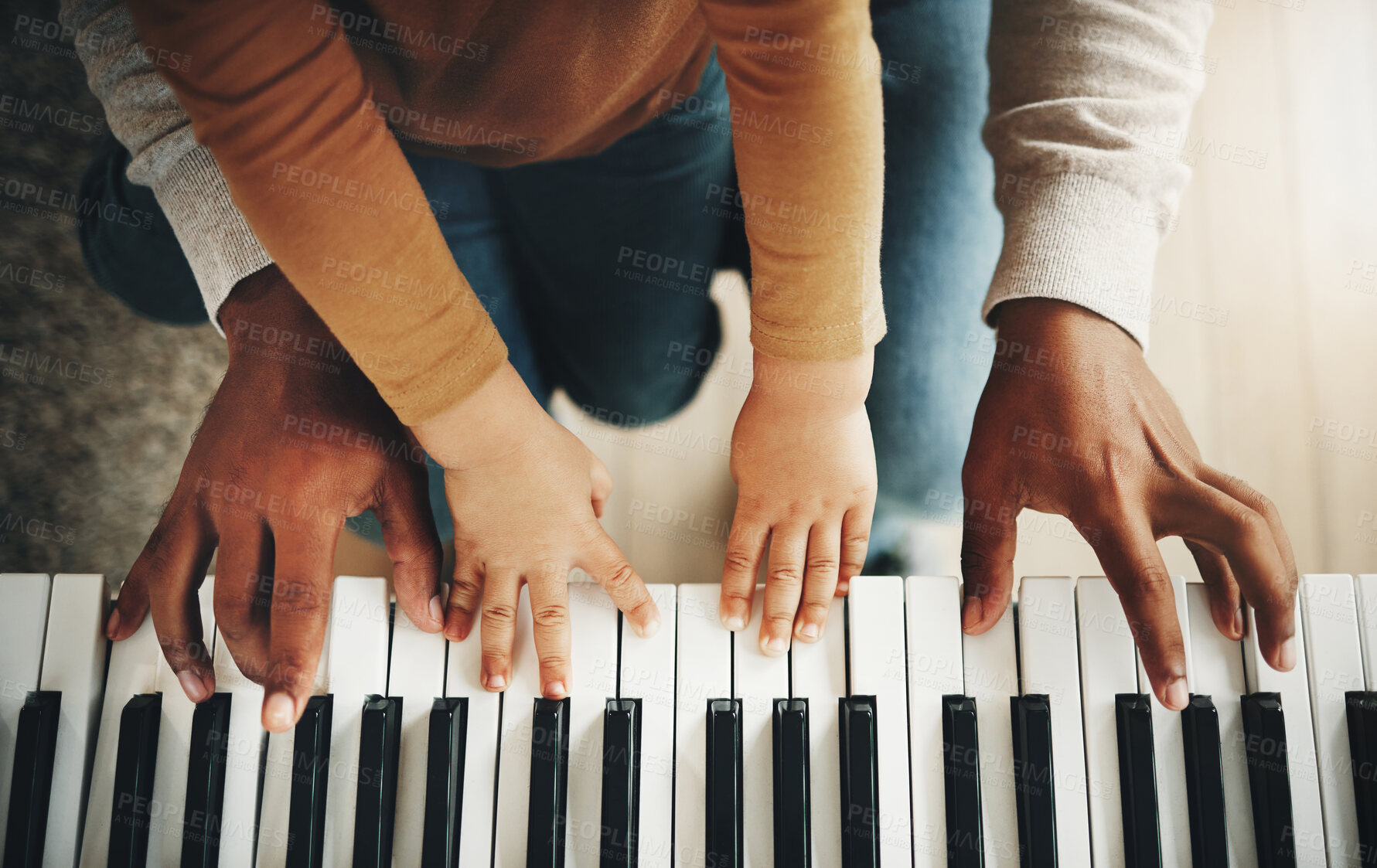 Buy stock photo Hands, parent and kid learning piano as development of skills together and bonding while making music in a home. Closeup, musical and child playing a song on an instrument and father teaching