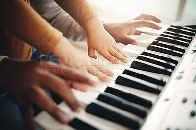 Buy stock photo Hands, parent and child playing piano as development of skills together and bonding while making music in a home. Closeup, musical and kid learning a song on an instrument and father teaching