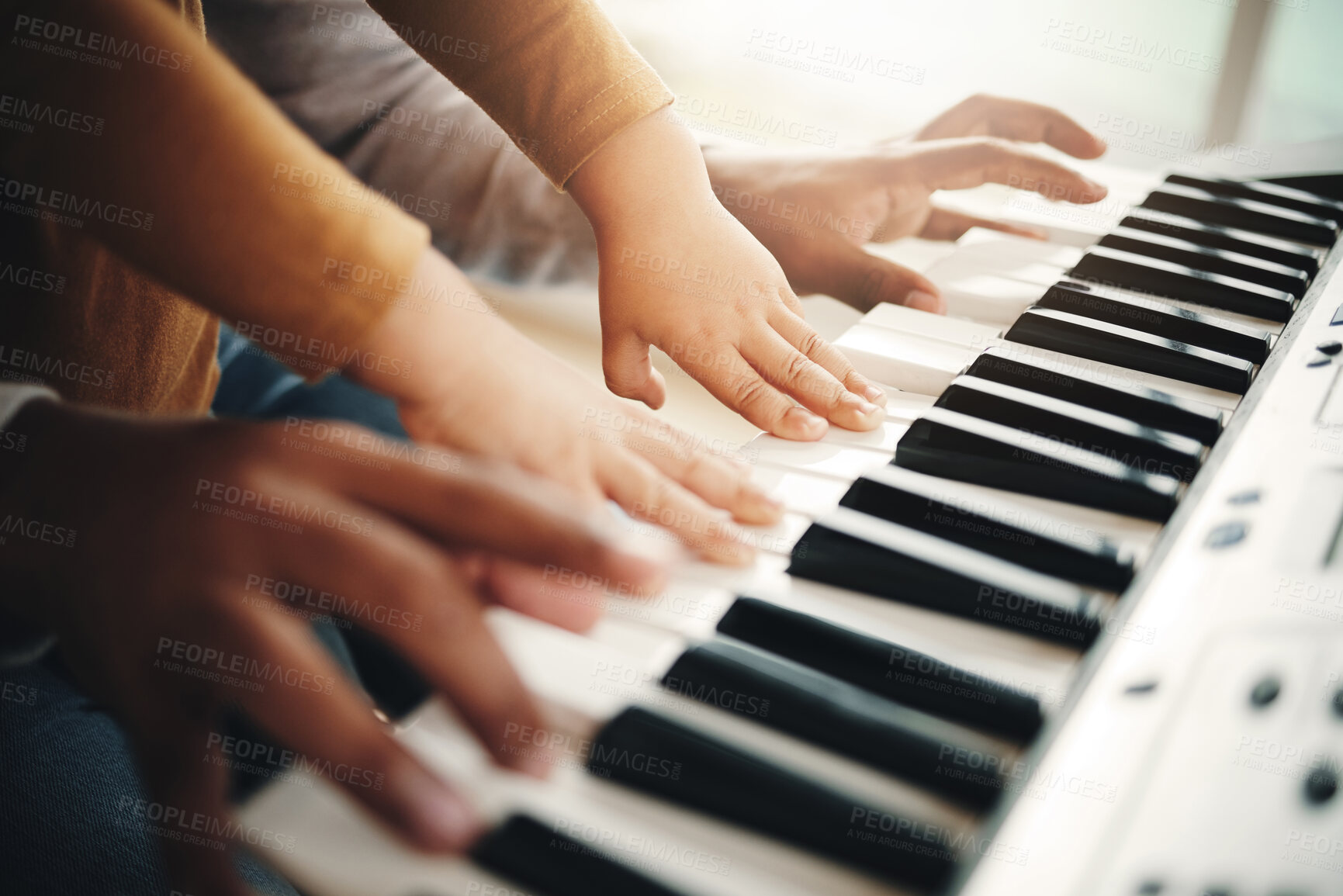 Buy stock photo Hands, parent and child playing piano as development of skills together and bonding while making music in a home. Closeup, musical and kid learning a song on an instrument and father teaching