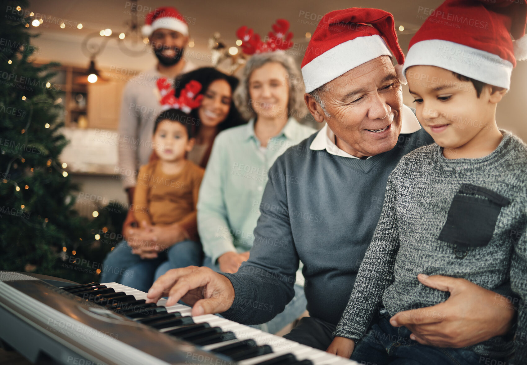 Buy stock photo Family, christmas and grandfather with grandchild on piano for learning, teaching and bond in their home. Music, instrument and retired pianist performing for kids and parents in festive celebration