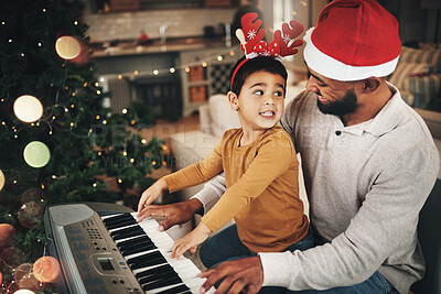 Buy stock photo Happy family, father and kid at piano for christmas celebration, song and xmas at home. Parent, boy child and teaching keyboard instrument, festive music or celebrate holiday spirit together in house