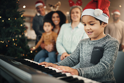 Buy stock photo Boy child, music keyboard and christmas in family home with smile, playing and creative with happiness. Kid, young musician and parents by piano for holiday cheer, bond and song for pride in house