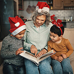 Christmas, photo album or memories with a grandmother and kids looking at photographs during festive season. Family, love or celebration with a senior woman and grandchildren holding a picture book