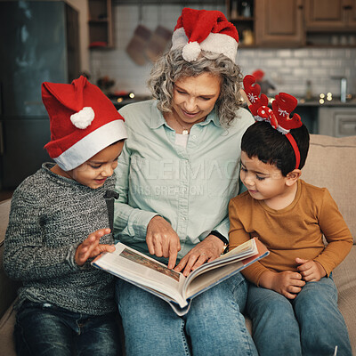 Buy stock photo Christmas, books or reading with a grandmother and kids looking at photographs during festive season. Family, love or celebration with a senior woman and grandchildren holding a story book