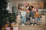 Christmas, big family and portrait smile in living room on sofa in home, bonding and care. Xmas, interracial and happy grandmother, grandfather and parents with kids or children enjoying holiday.