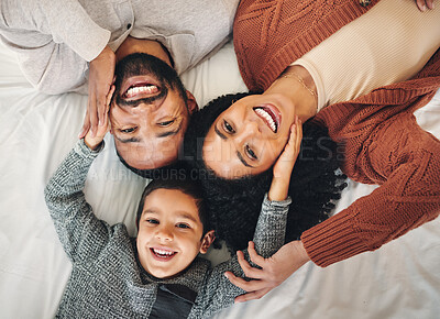 Buy stock photo Family, laughing and top view portrait on bed in bedroom, bonding and care in home. Love, smile and happy mother, comic father and funny boy child playing, having fun and enjoying joke time together.