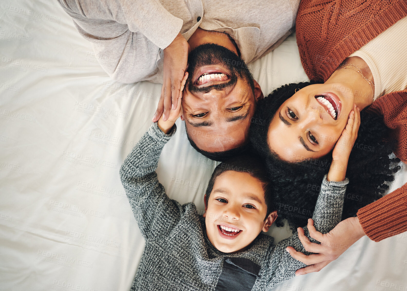 Buy stock photo Top view, love and family in bedroom, smile and quality time for joy, bonding and happiness. Portrait, parents and mother with father, boy and male child on bed, cheerful and relax with affection