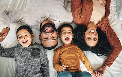 Buy stock photo Laughing, family and top view portrait on bed in bedroom, bonding and care in home. Love, smile and happy mother, comic father and funny children playing, having fun and enjoying joke time together.