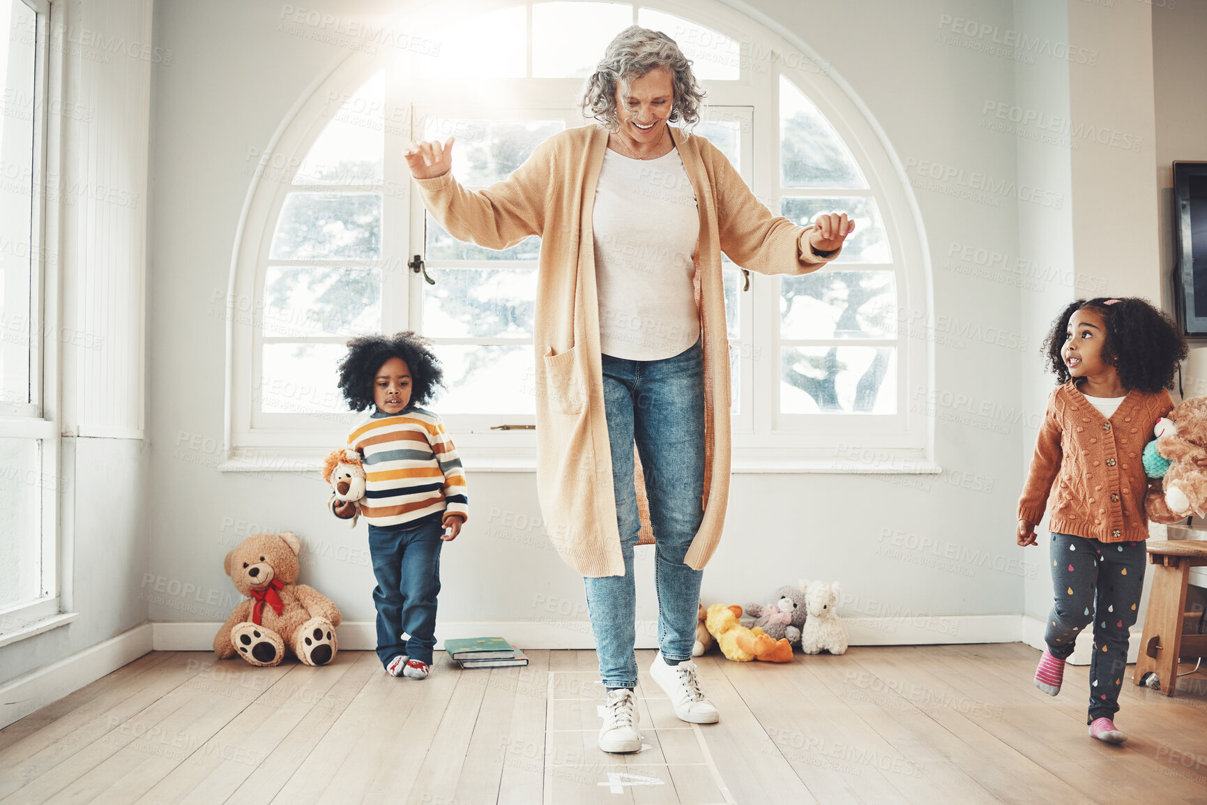 Buy stock photo Hopscotch, grandmother and children play in home having fun, enjoy games and balance together in bedroom. Happy family, entertainment and grandma with kids for jumping, playing and numbers activity