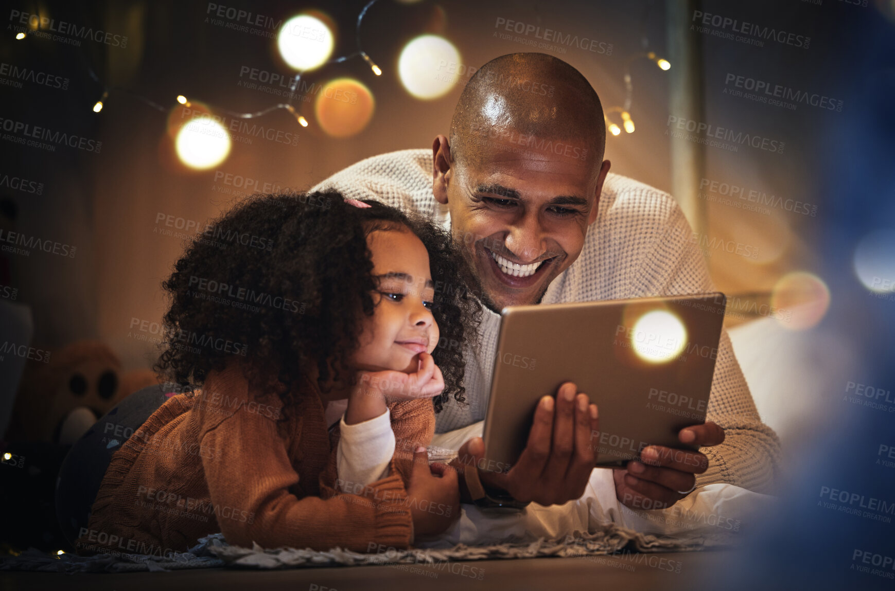 Buy stock photo Night, tablet and relax with father and daughter in blanket tent for connection, happy and streaming cartoon. Smile, app and fairy lights with man and girl at home for education, internet and online