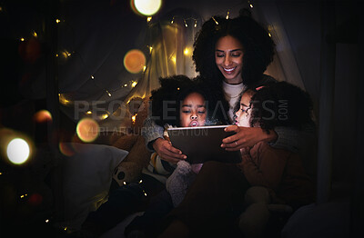 Buy stock photo Mother, kids and tablet in home tent, streaming movie or video, having fun and bonding. Mixed race family, care and happy mama, children or girls with touchscreen tech for internet browsing at night.