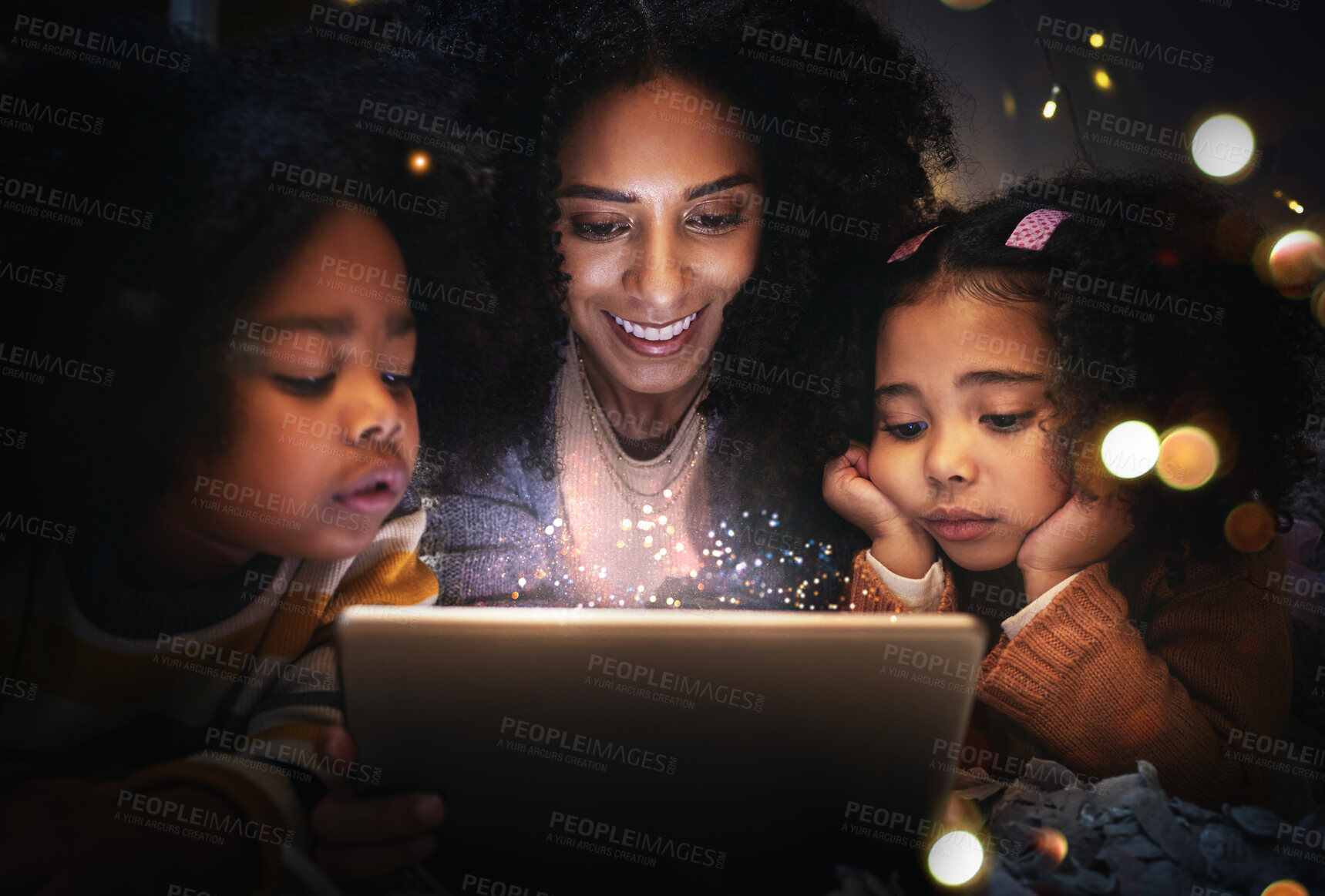 Buy stock photo Tablet, night a woman reading to her children in a tent while camping in the bedroom of their home together. Black family, story or kids with a mother storytelling to her kids at bedtime for bonding