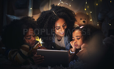 Buy stock photo Tablet, night a mother reading to her children in a tent while camping in the bedroom of their home together. Black family, story or kids with a woman storytelling to her kids at bedtime for bonding