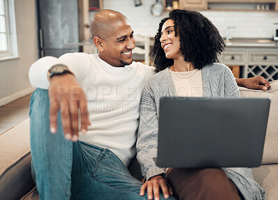 Buy stock photo Happy, love and couple on a sofa with laptop in the living room of their modern house. Happiness, romantic and young man and woman in conversation while browsing on social media or internet together.