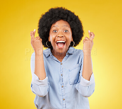 Buy stock photo Happy, portrait and fingers crossed by black woman in studio for wish, hope and good luck against yellow background. Face, hands and emoji by excited female with wow, surprised and hopeful gesture