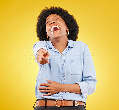 Buy stock photo Pointing, laughing and fun with a black woman in studio on a yellow background enjoying a funny joke. Comic, comedy and laughter with an attractive young female feeling silly, goofy or playful