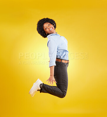 Buy stock photo Happy, excited and portrait of black woman jump on yellow background with energy, happiness and smile in studio. Winner mockup, celebration and isolated girl jumping for freedom, winning and success