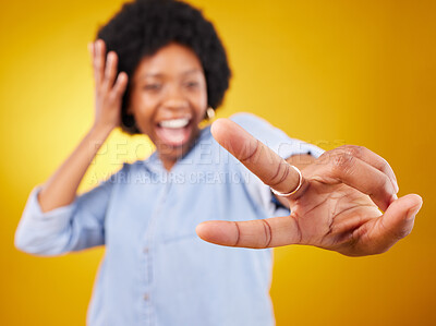 Buy stock photo Happy, peace sign and hand of a black woman in studio with a positive and goofy mindset. African female model posing with finger gesture while happy about motivation or victory on yellow background