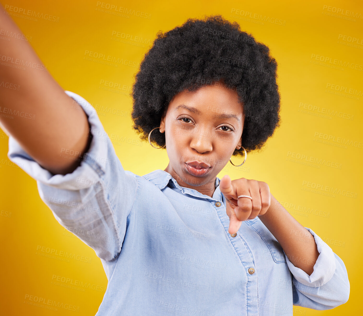 Buy stock photo Portrait, selfie and black woman pointing to you in studio isolated on a yellow background. Face, emoji and serious female model taking photo for profile picture or social media with hand gesture.